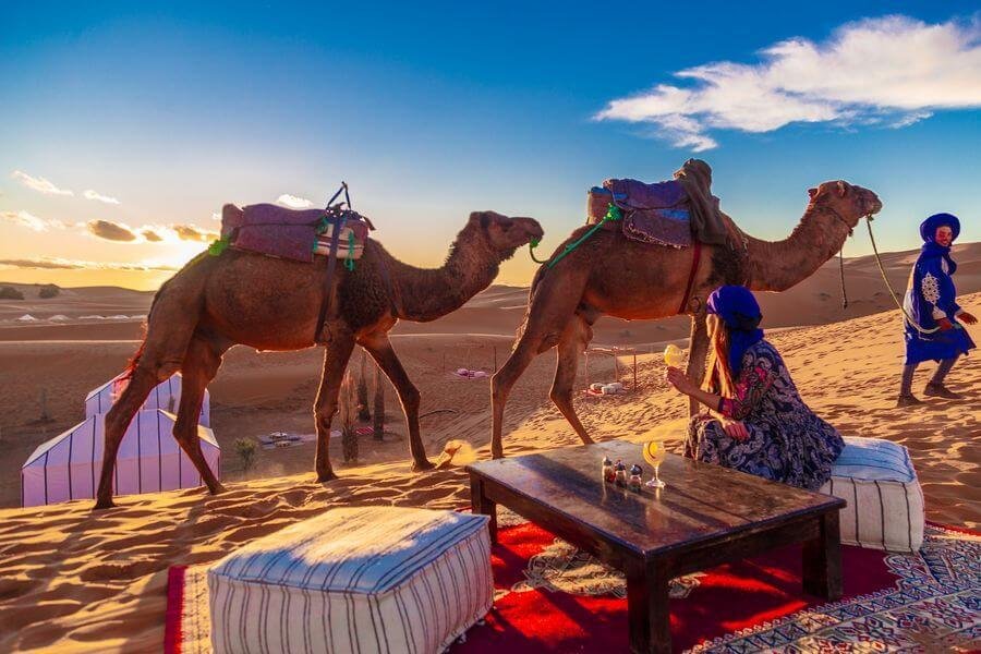 Tourists enjoying a sunset view in the Merzouga desert on a 4-day Marrakech itinerary - View 3